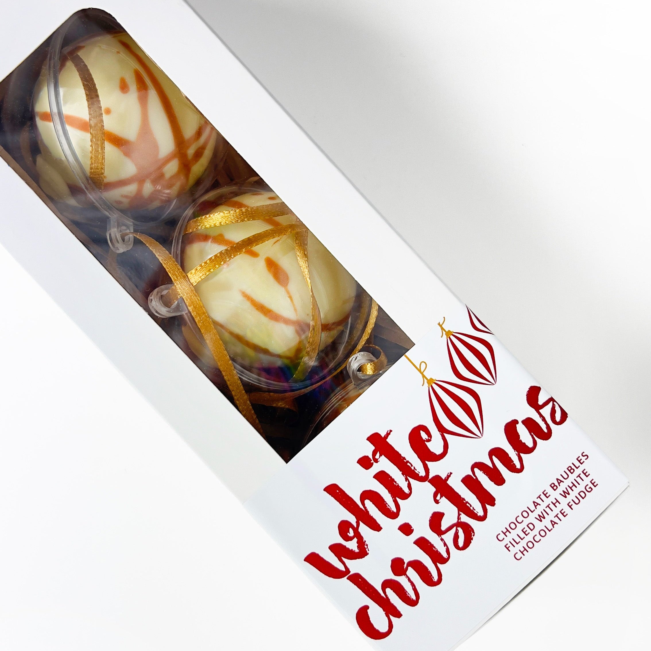 Chocolate baubles in a box with 'White Christmas' branding on a white background