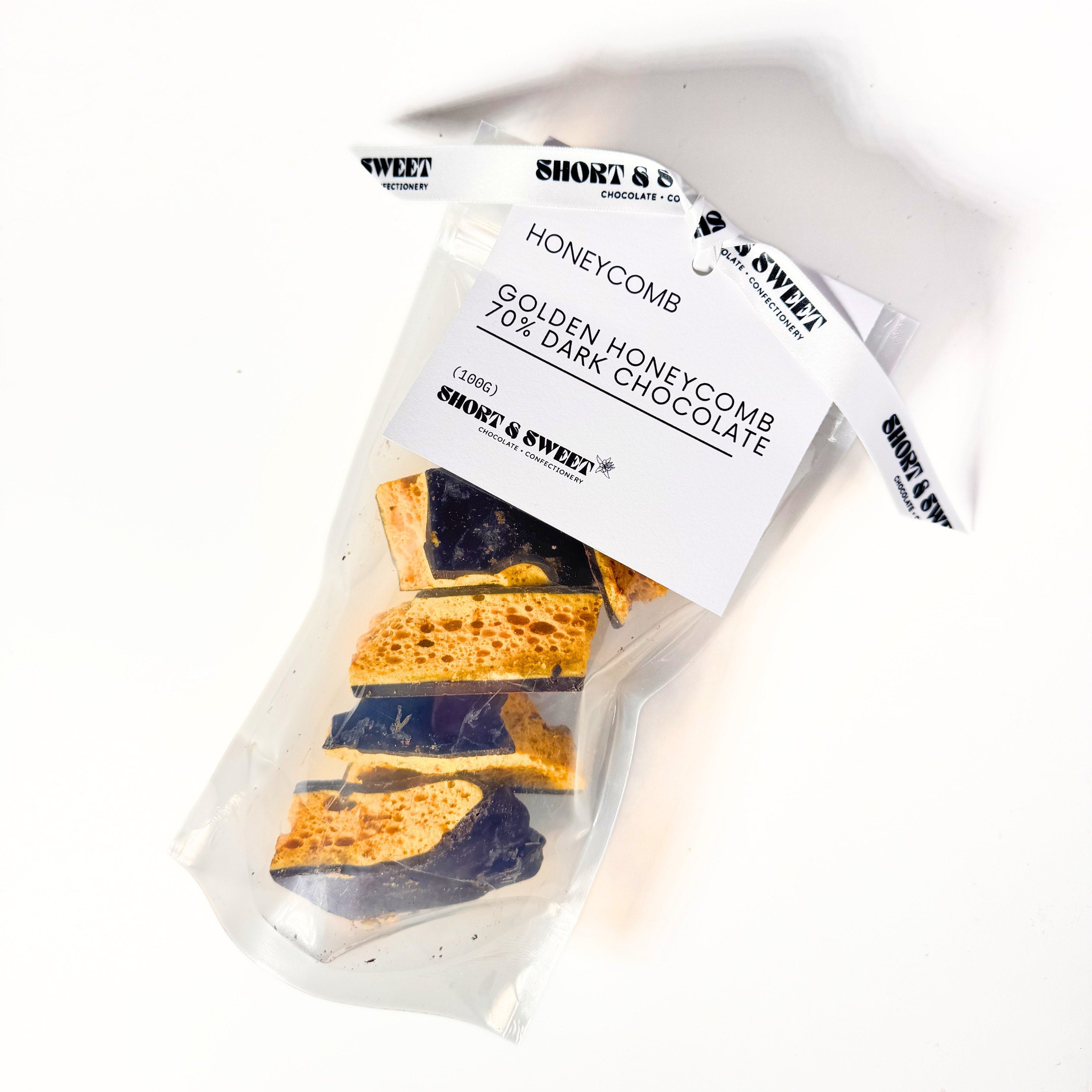 Packaged honeycomb with dark chocolate on a white background