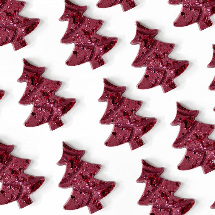 Pattern of ruby chocolate Christmas trees on a white background