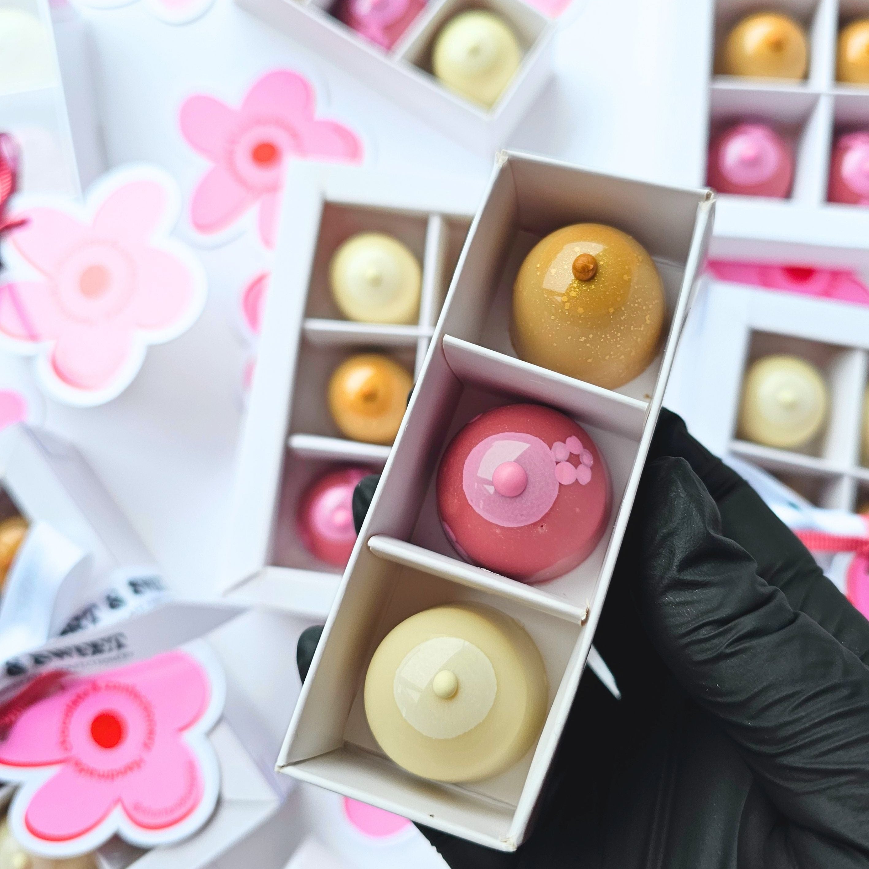 Decorative boxes with bonbons inside a floral background