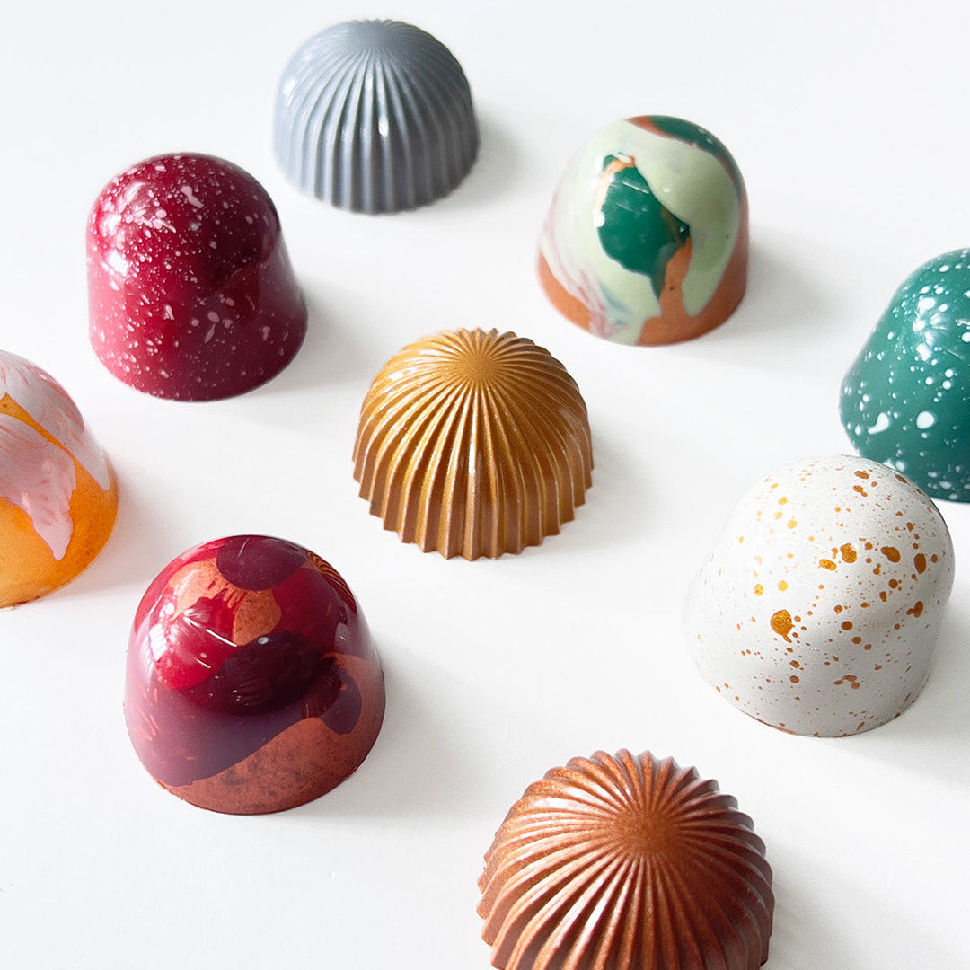 Assorted colorful chocolates on a white background