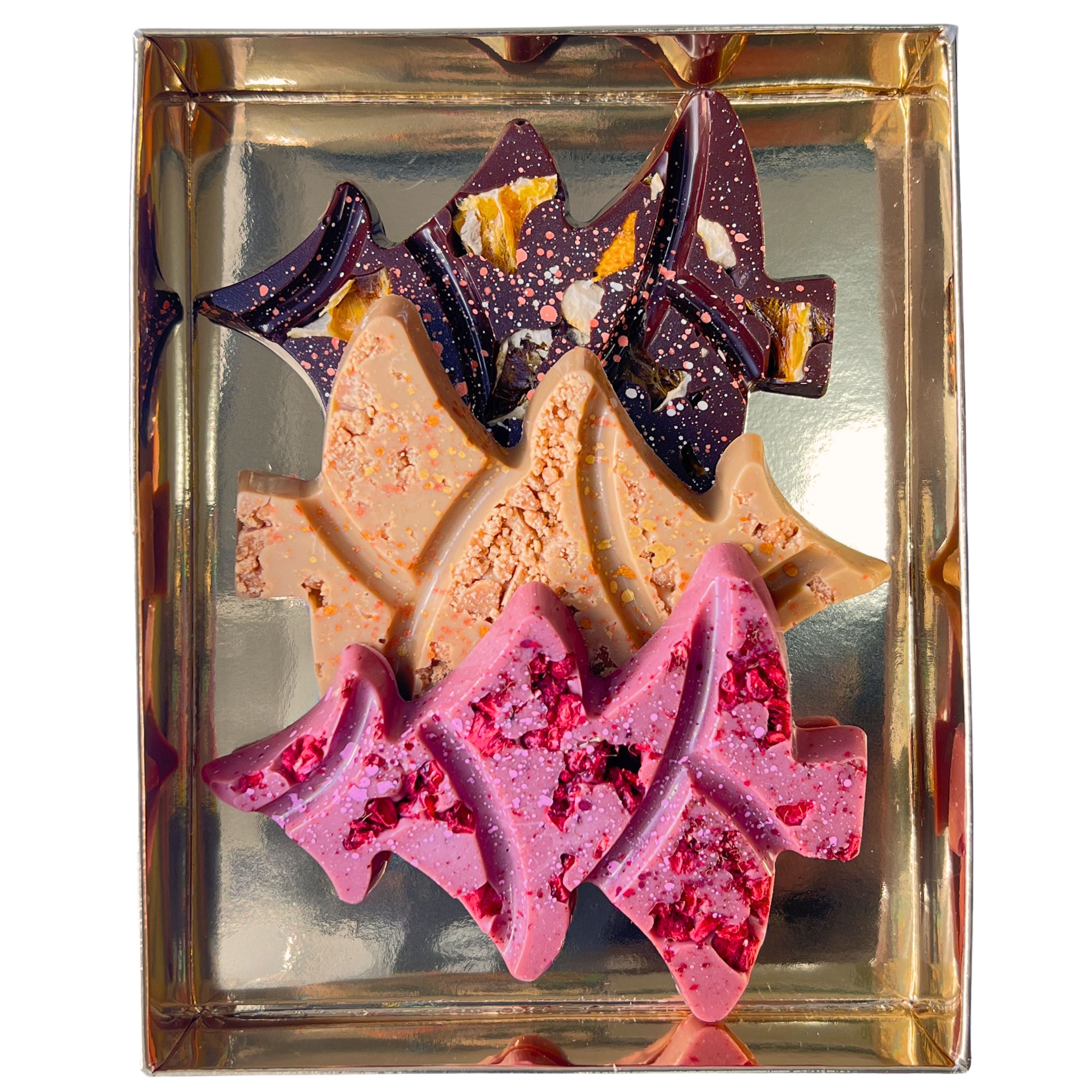 Colorful chocolate pieces in a decorative box with a gold base.