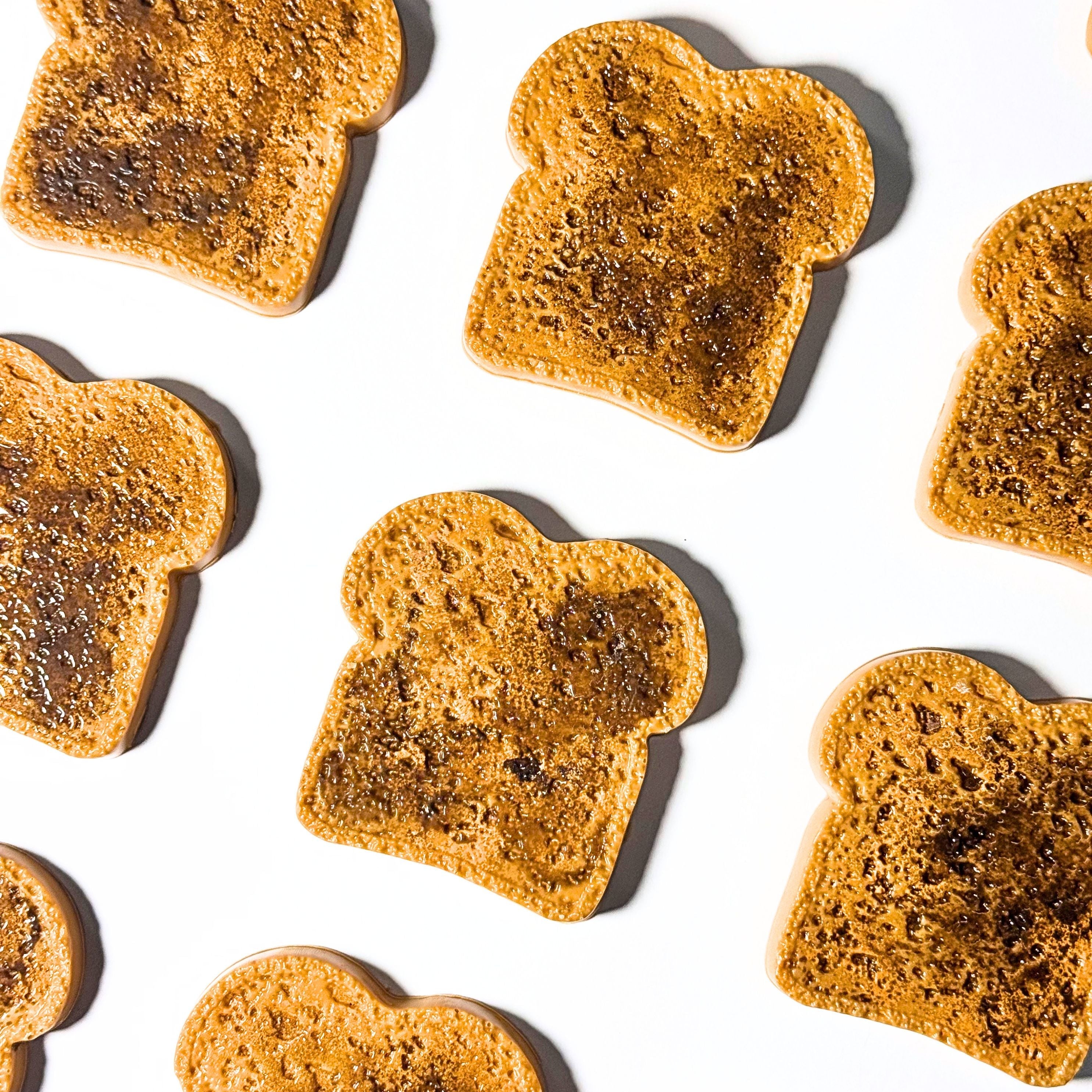 Pattern of toasted bread slices on a white background